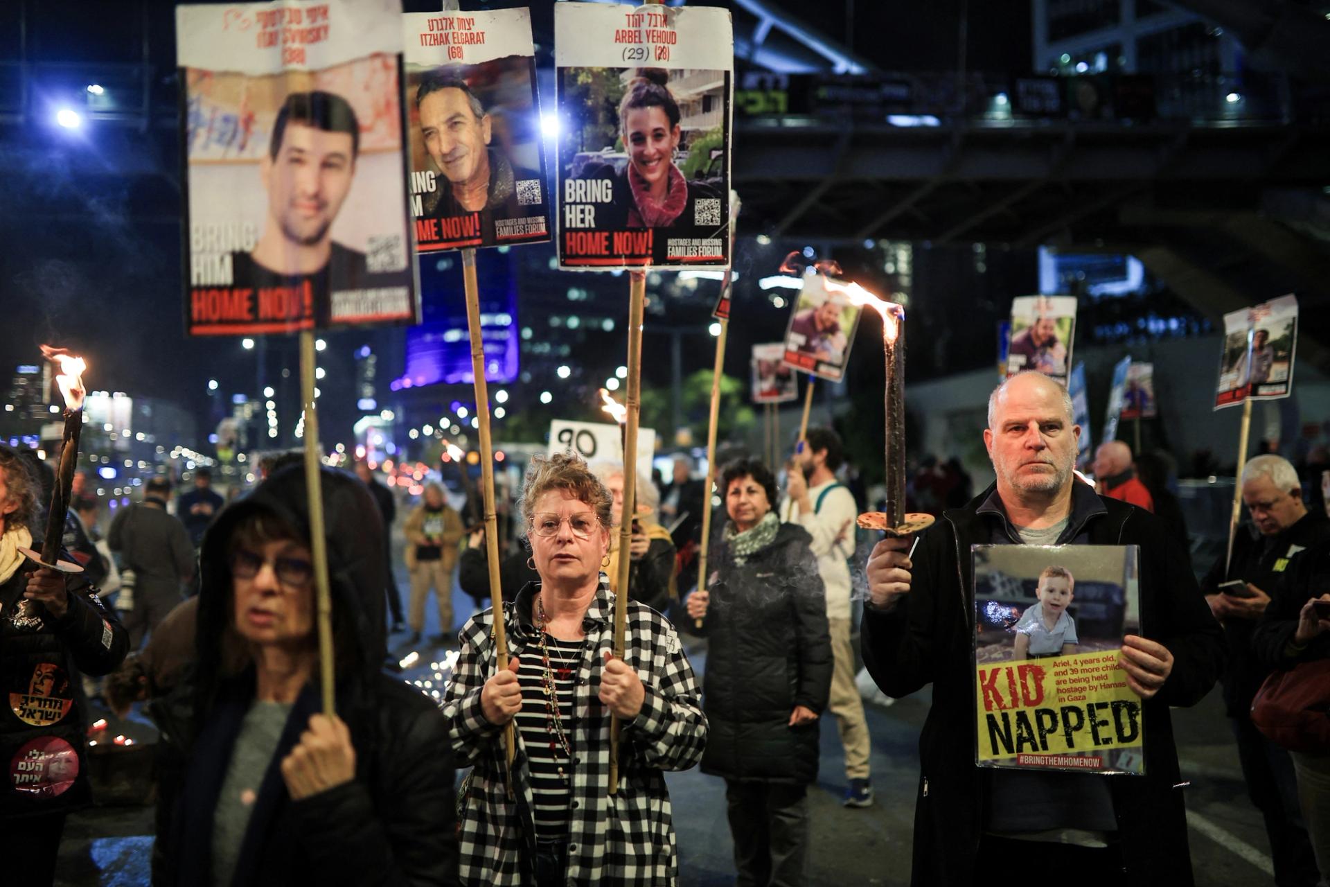 Relatives and supporters of Israeli hostages, kidnapped during the deadly October 7 2023 attack by Hamas, hold pictures of hostages.