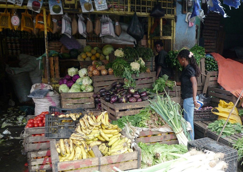 A person at a fruit and vegetable stall in Ethiopia.