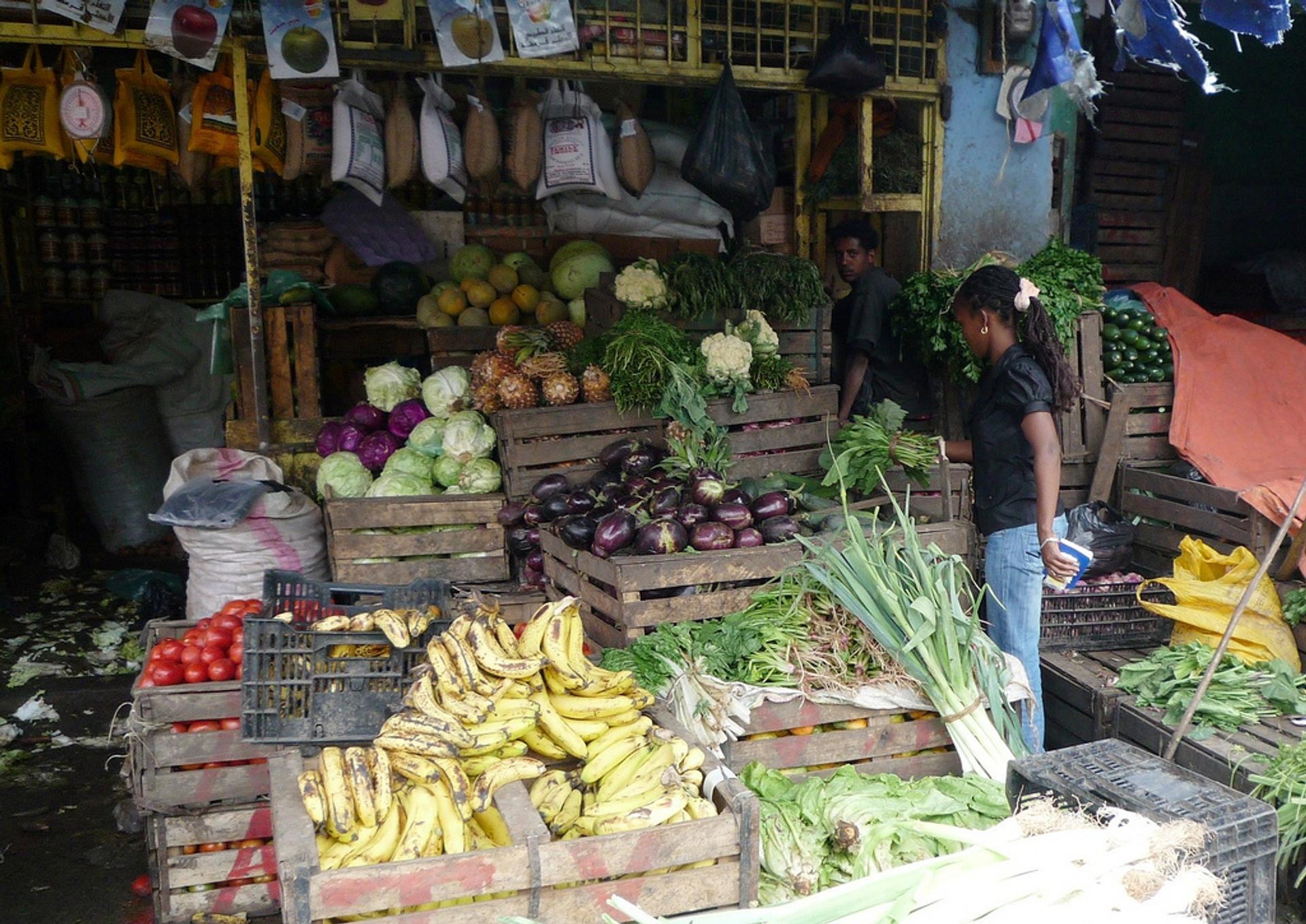 A person at a fruit and vegetable stall in Ethiopia.