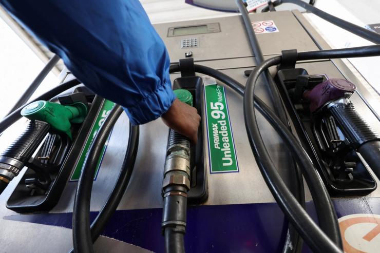 A worker holds a pump at a petrol station in Cape Town, South Africa.
