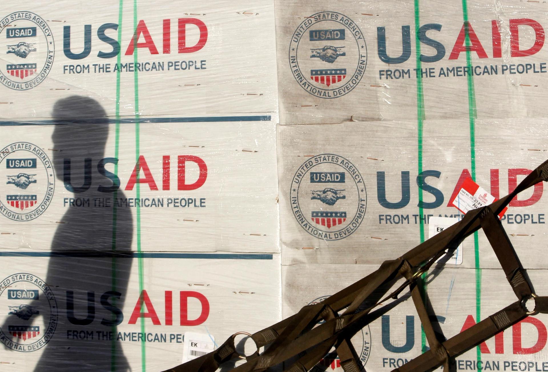 The shadow of a Philippine Army personnel is cast on boxes of relief items from U.S. Agency for International Development (USAID) for the victims of super typhoon Haiyan, at Villamor Air Base in Manila November 13, 2013.