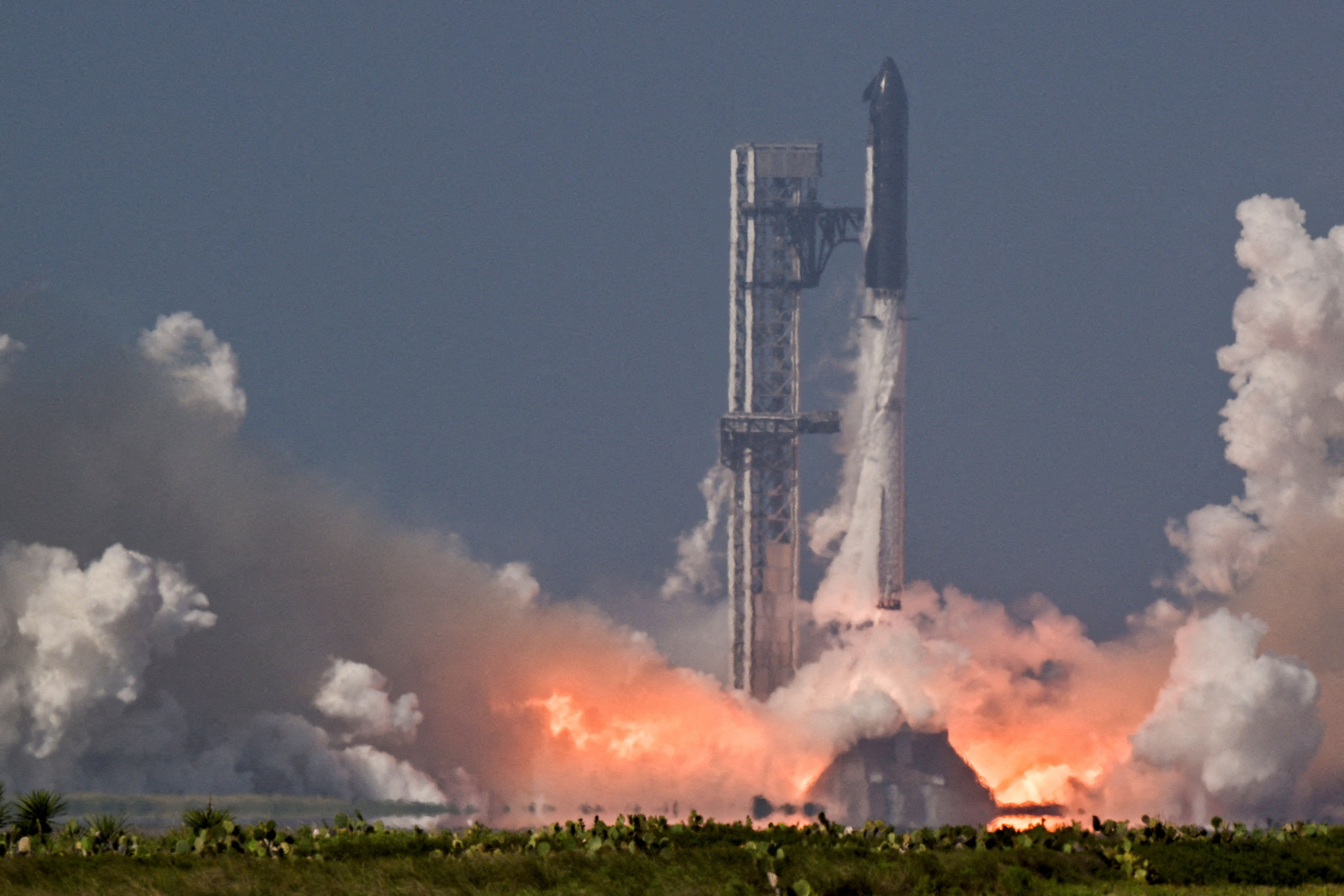 A SpaceX Super Heavy booster carrying the Starship spacecraft lifts off.