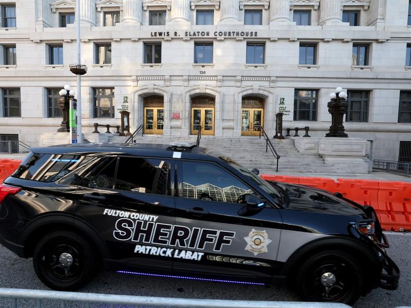 A sheriff's vehicle passes by the Lewis R. Slaton Courthouse and Superior Court of Fulton County.