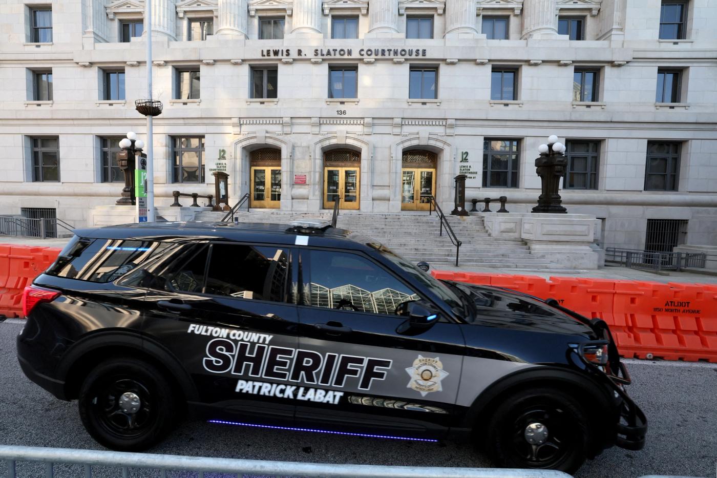 A sheriff's vehicle passes by the Lewis R. Slaton Courthouse and Superior Court of Fulton County.