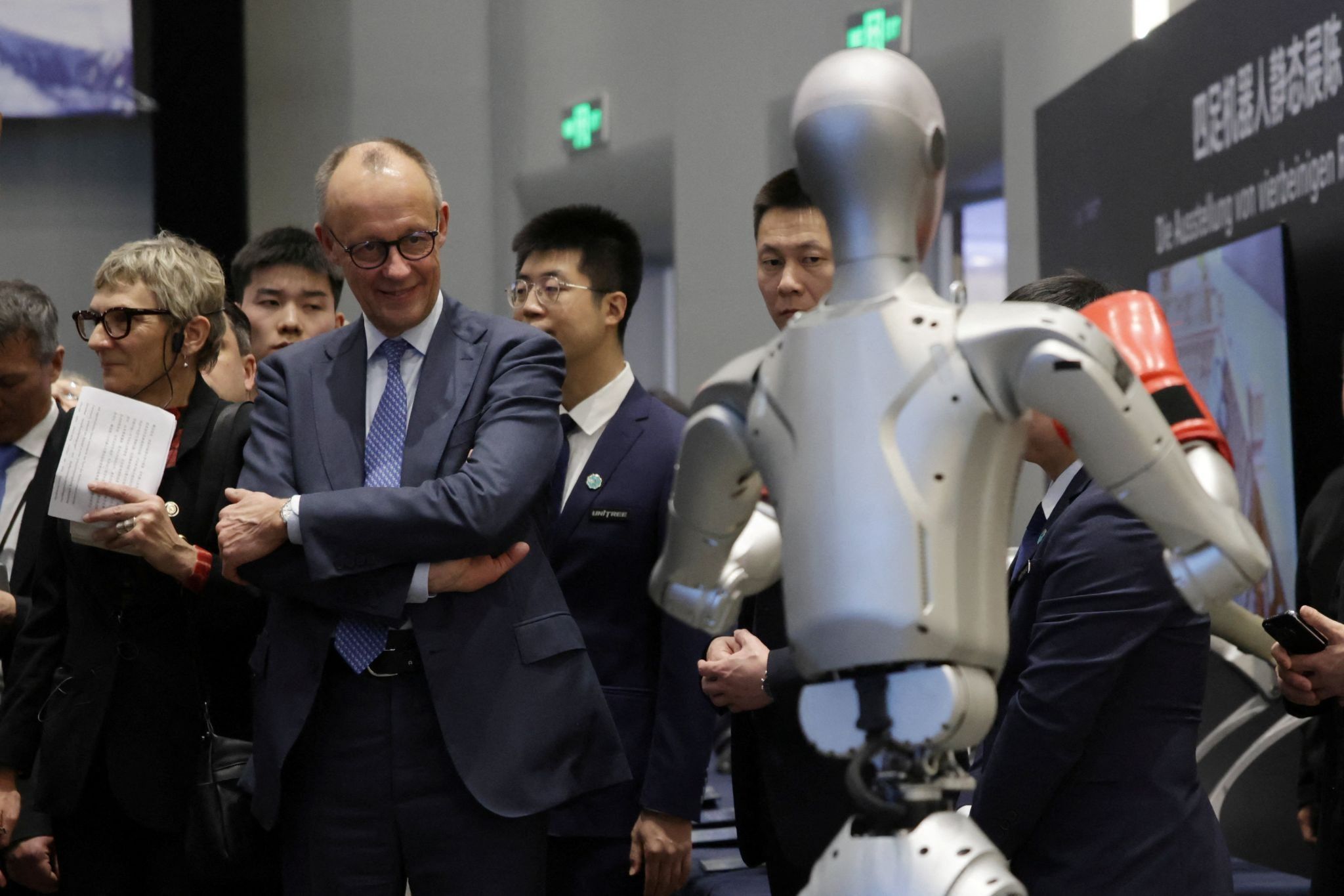 German Chancellor Friedrich Merz attends a performance of a humanoid robot boxing at the Unitree Robotics headquarters during the last day of his official visit to China