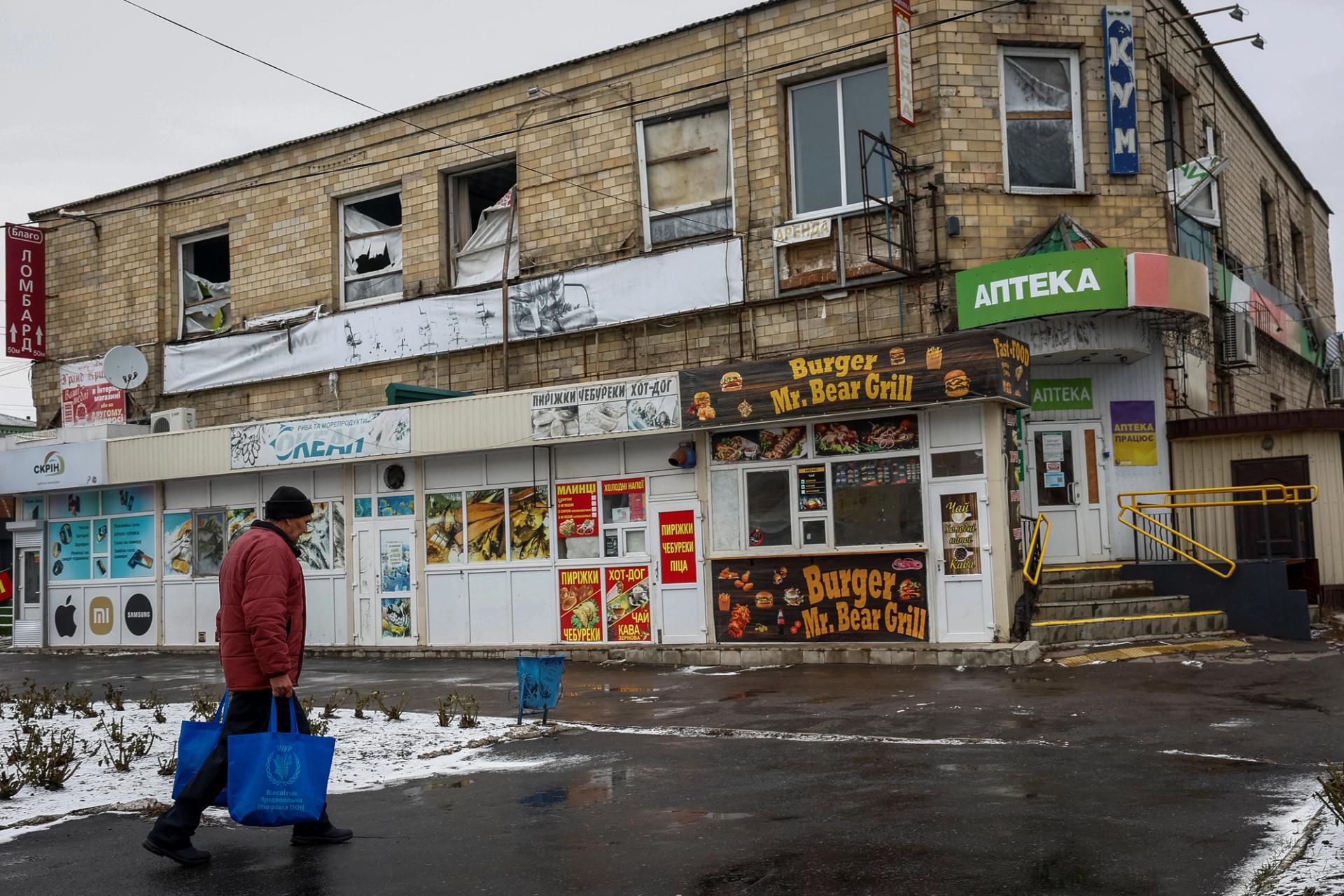 A local resident walks by a damaged building, amid Russia’s attack on Ukraine, in the town of Pokrovsk, near a front line in Donetsk region, Ukraine.