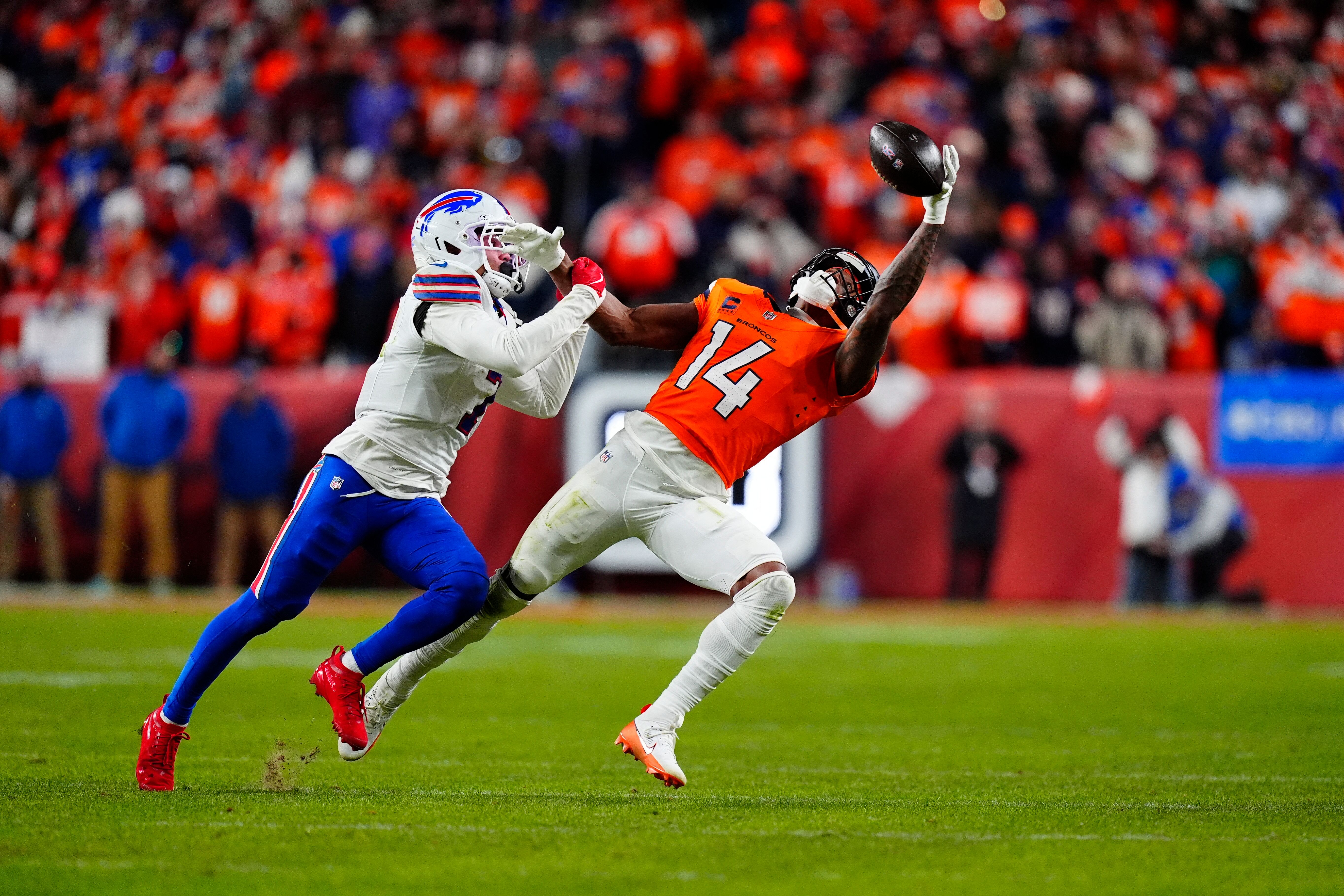 Jan 17, 2026; Denver, CO, USA; Buffalo Bills cornerback Taron Johnson (7) is called for pass interference on Denver Broncos wide receiver Courtland Sutton (14) during overtime of an AFC Divisional Round playoff game at Empower Field at Mile High.