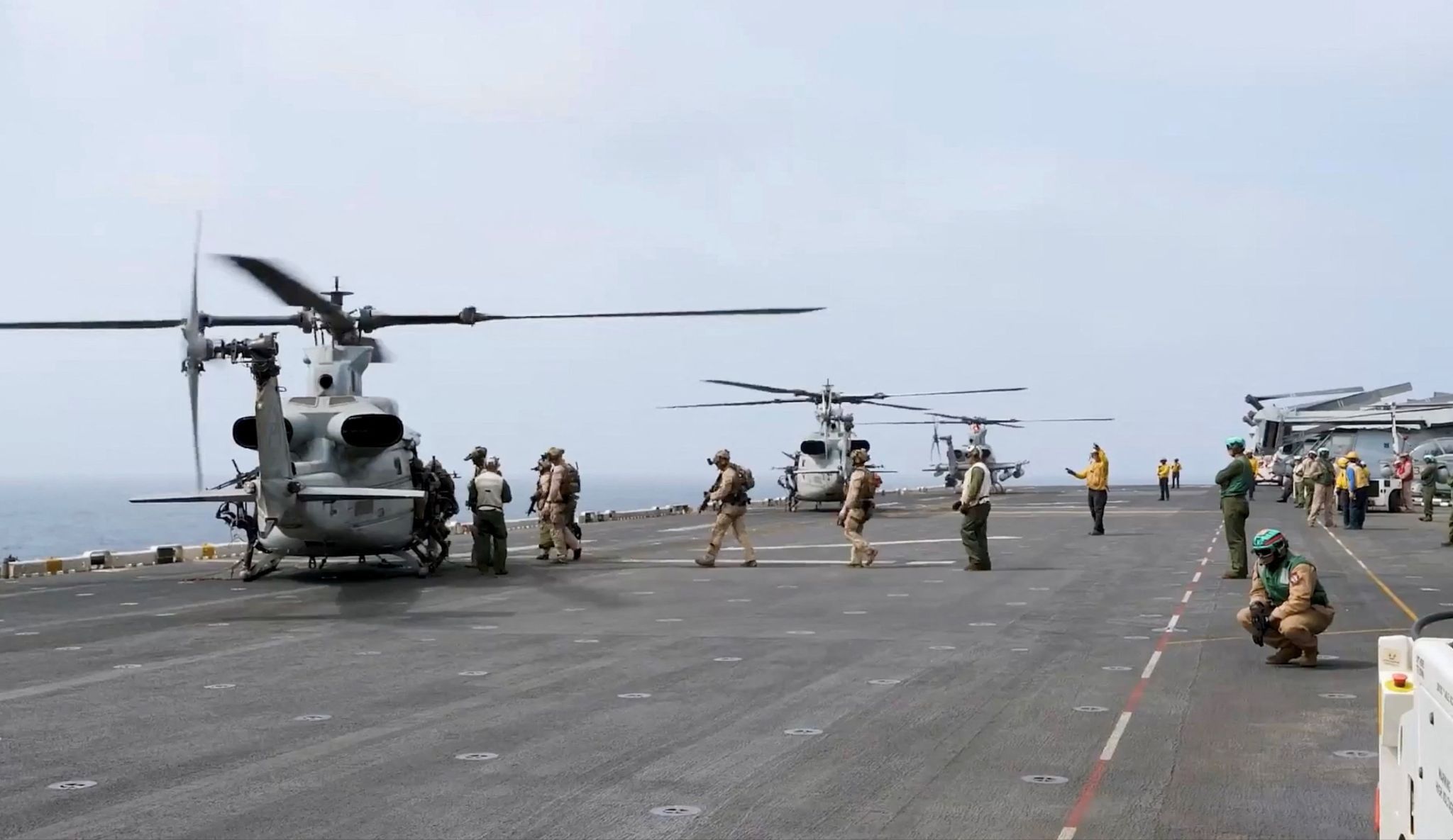 Military helicopters and personnel operate in a location given as the Arabian Sea. US Central Command/Handout via Reuters.