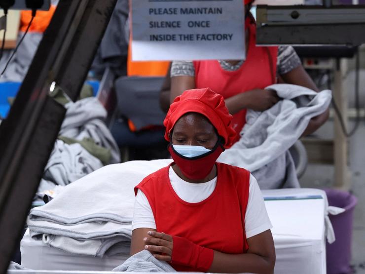 A Kenyan worker prepares clothes for export.