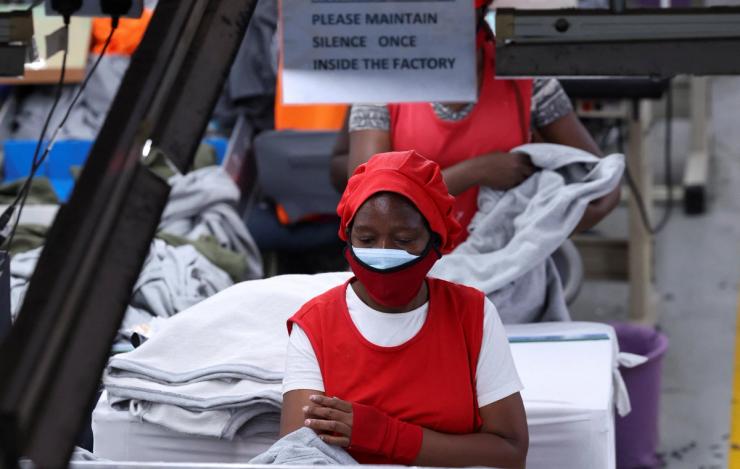 A Kenyan worker prepares clothes for export.
