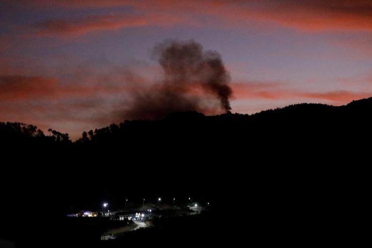 Smoke rises near Fort Tiuna during a full blackout, following explosions and loud noise in Caracas.