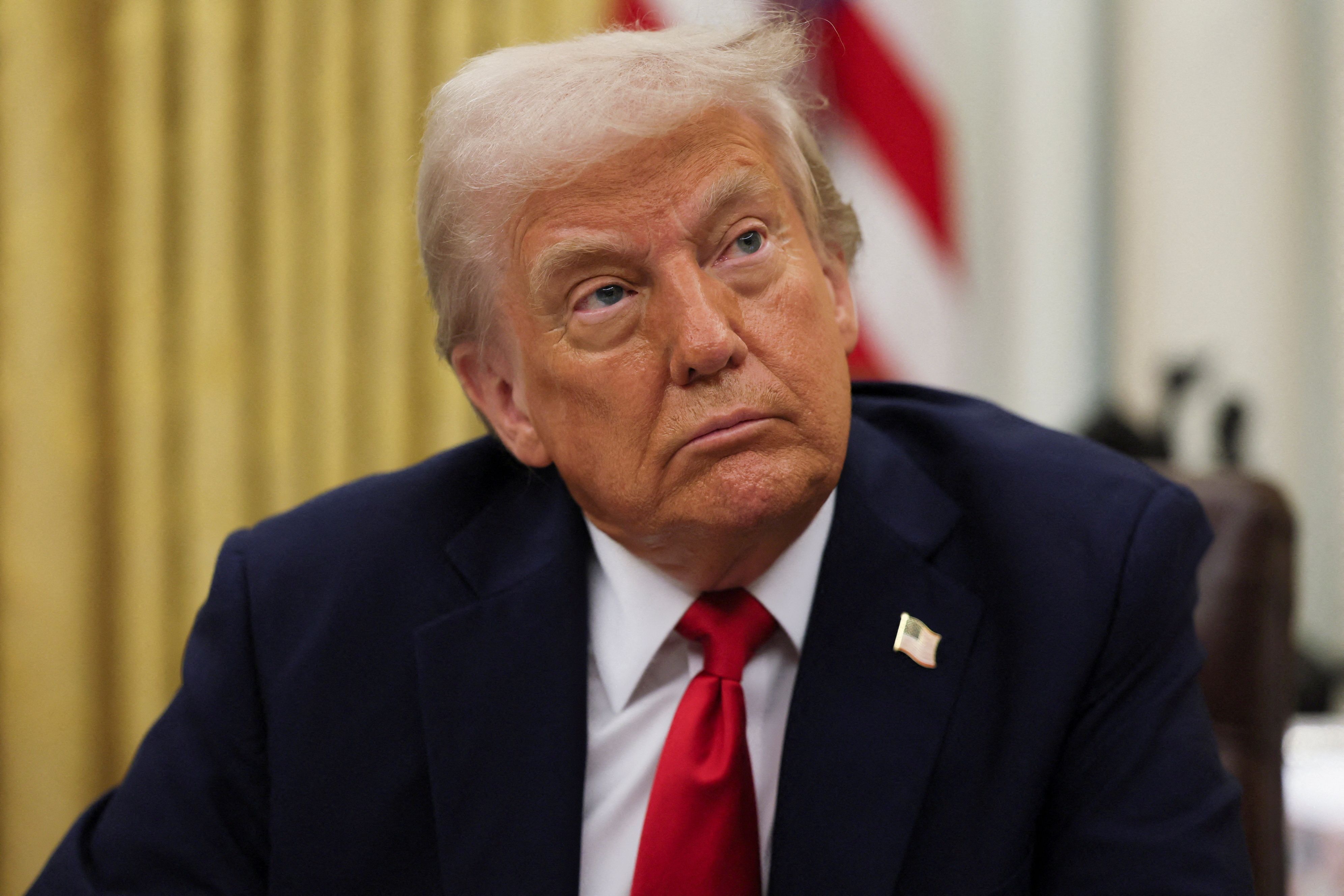 President Donald Trump prepates to sign an executive order in the Oval Office on March 31, 2025.