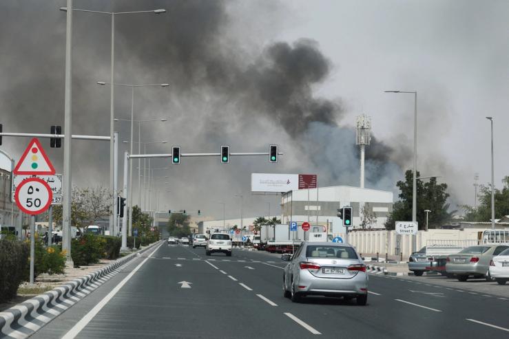 Smoke rises after reported Iranian missile attacks as seen from Doha.