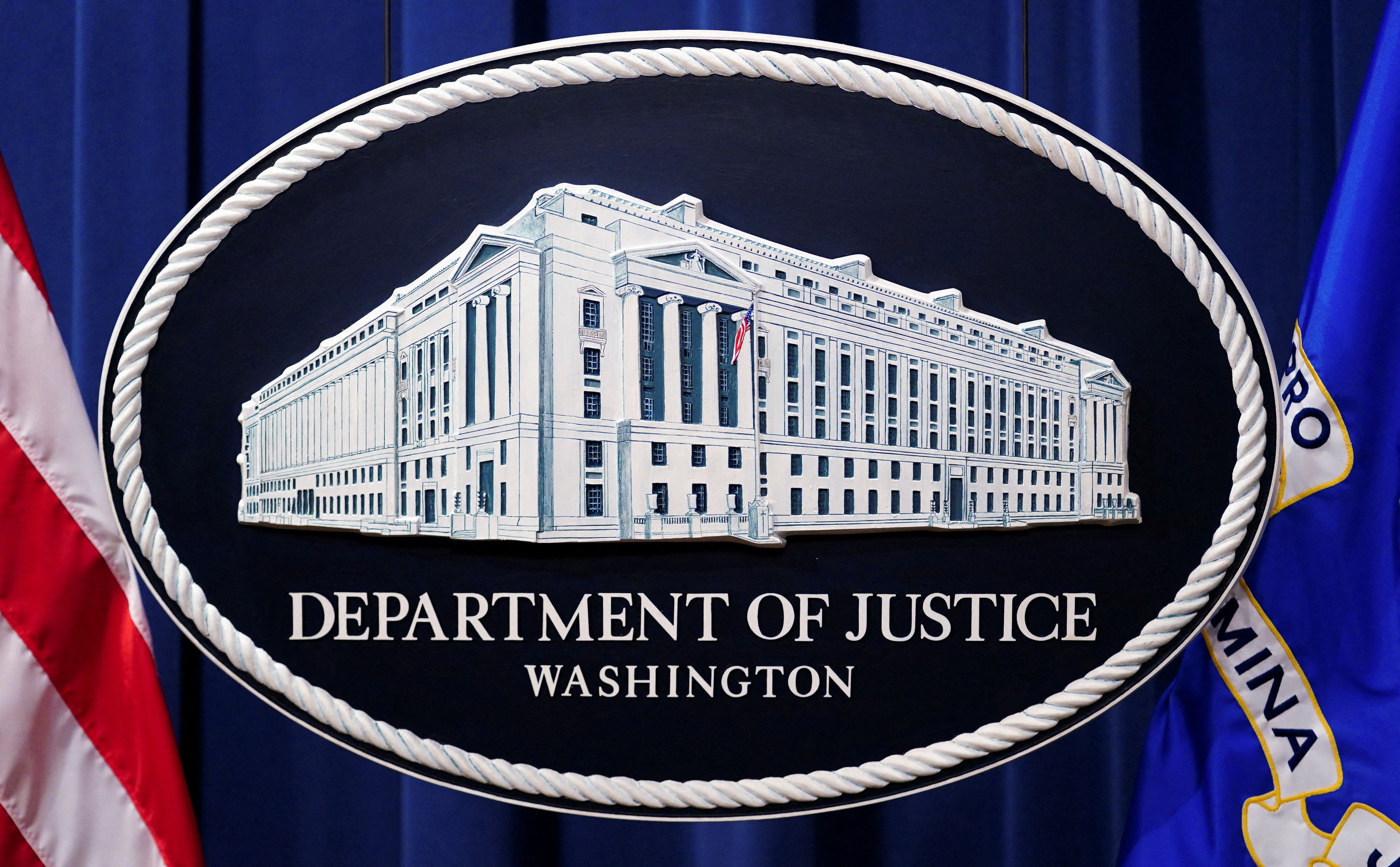 A Justice Department logo or seal showing Justice Department headquarters.