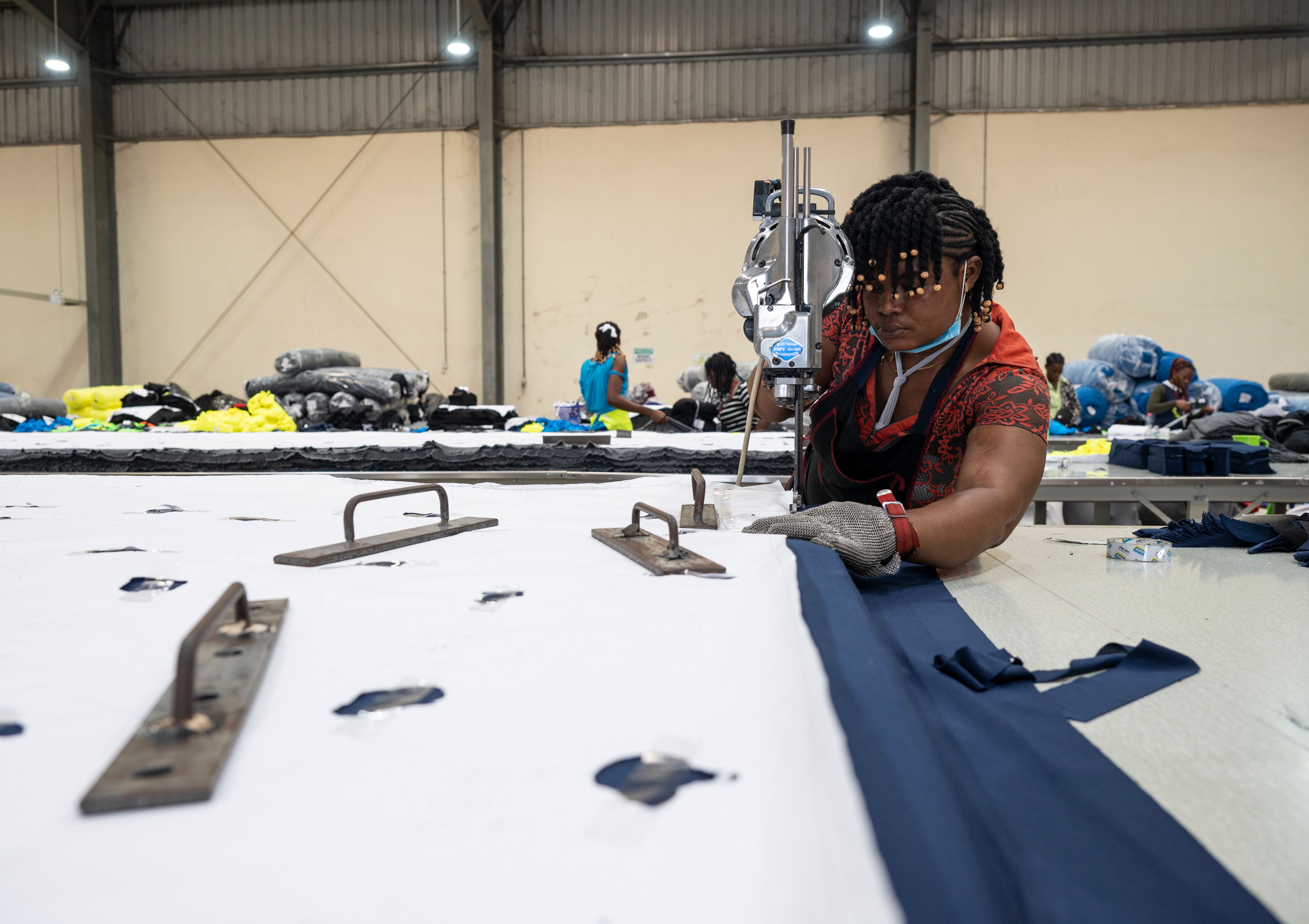 Promise Agyapong cuts fabric at a DTRT apparel factory in Tema, Ghana.