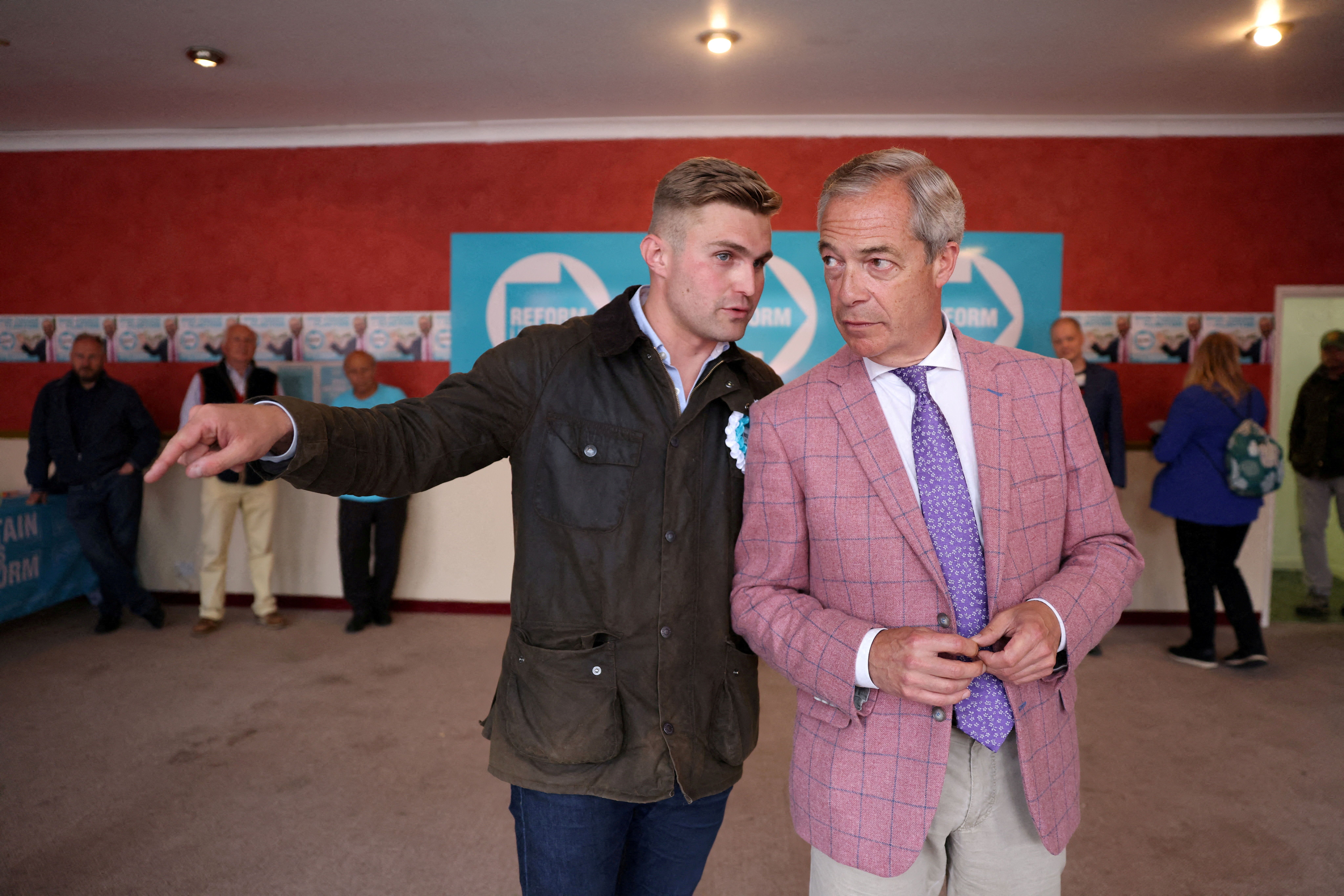 Nigel Farage with an aide. 