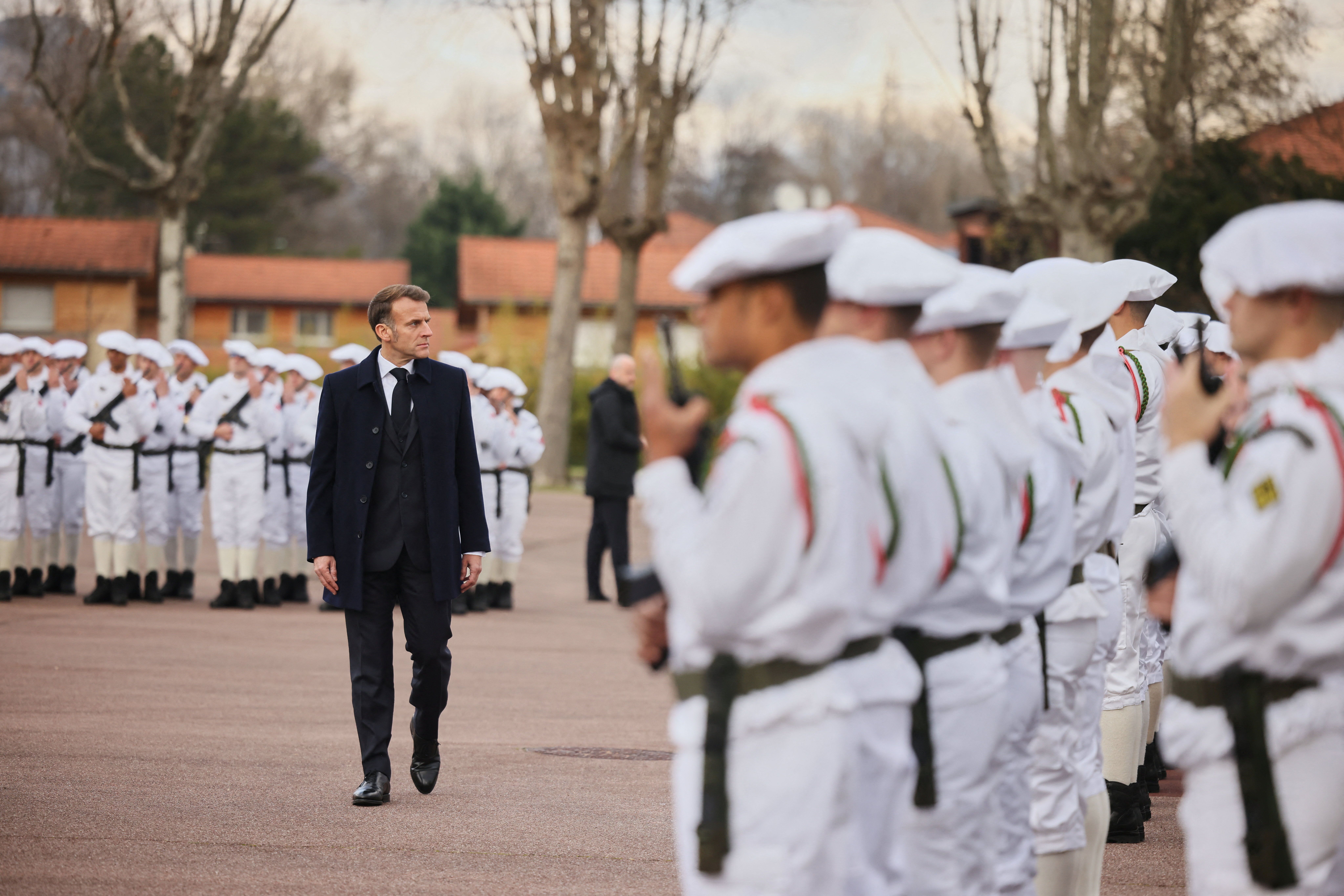 French President Emmanuel Macron surveys French troops