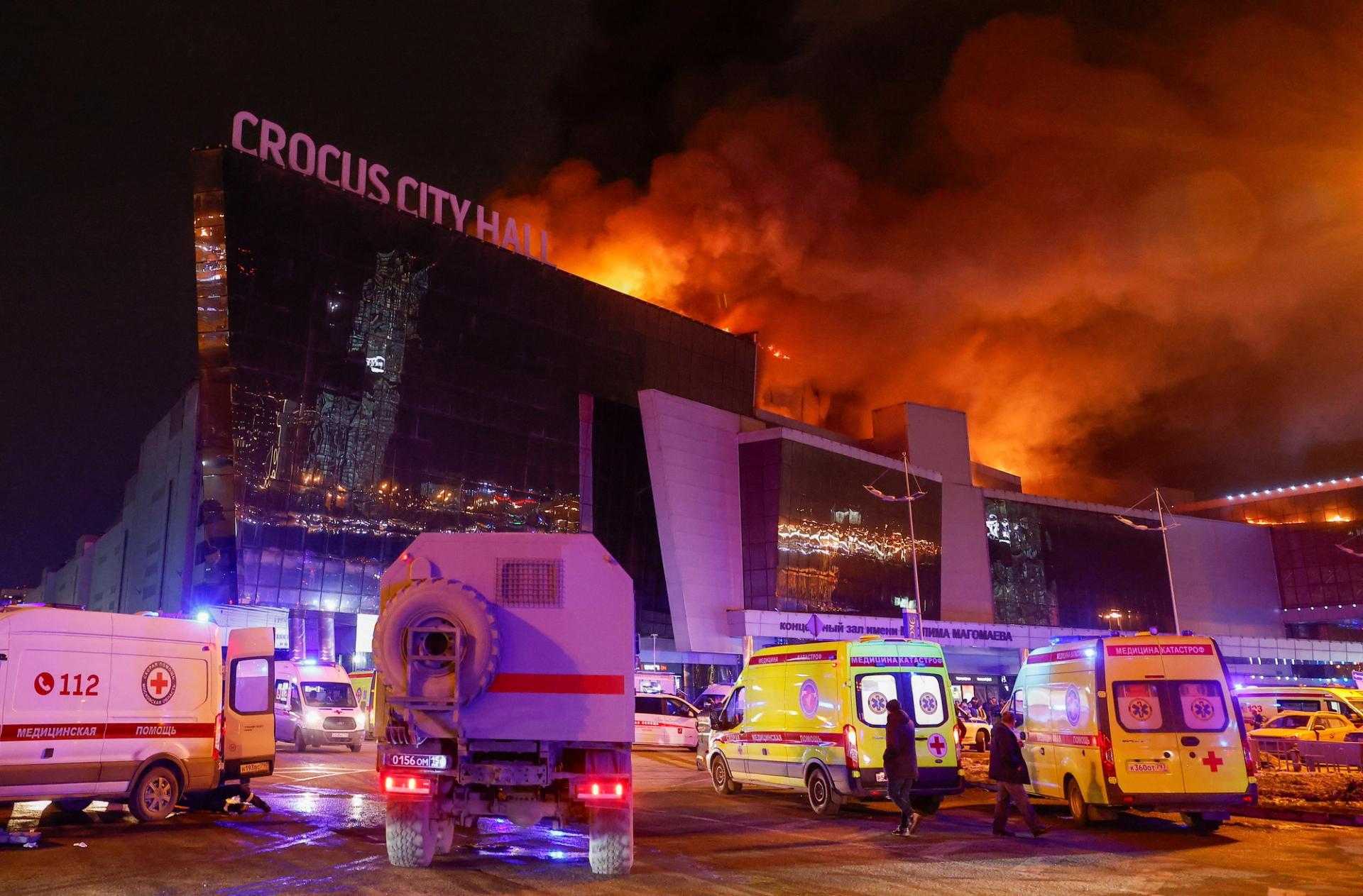 Vehicles of Russian emergency services are parked near the burning Crocus City Hall concert venue following a shooting incident in the outskirts of Moscow.