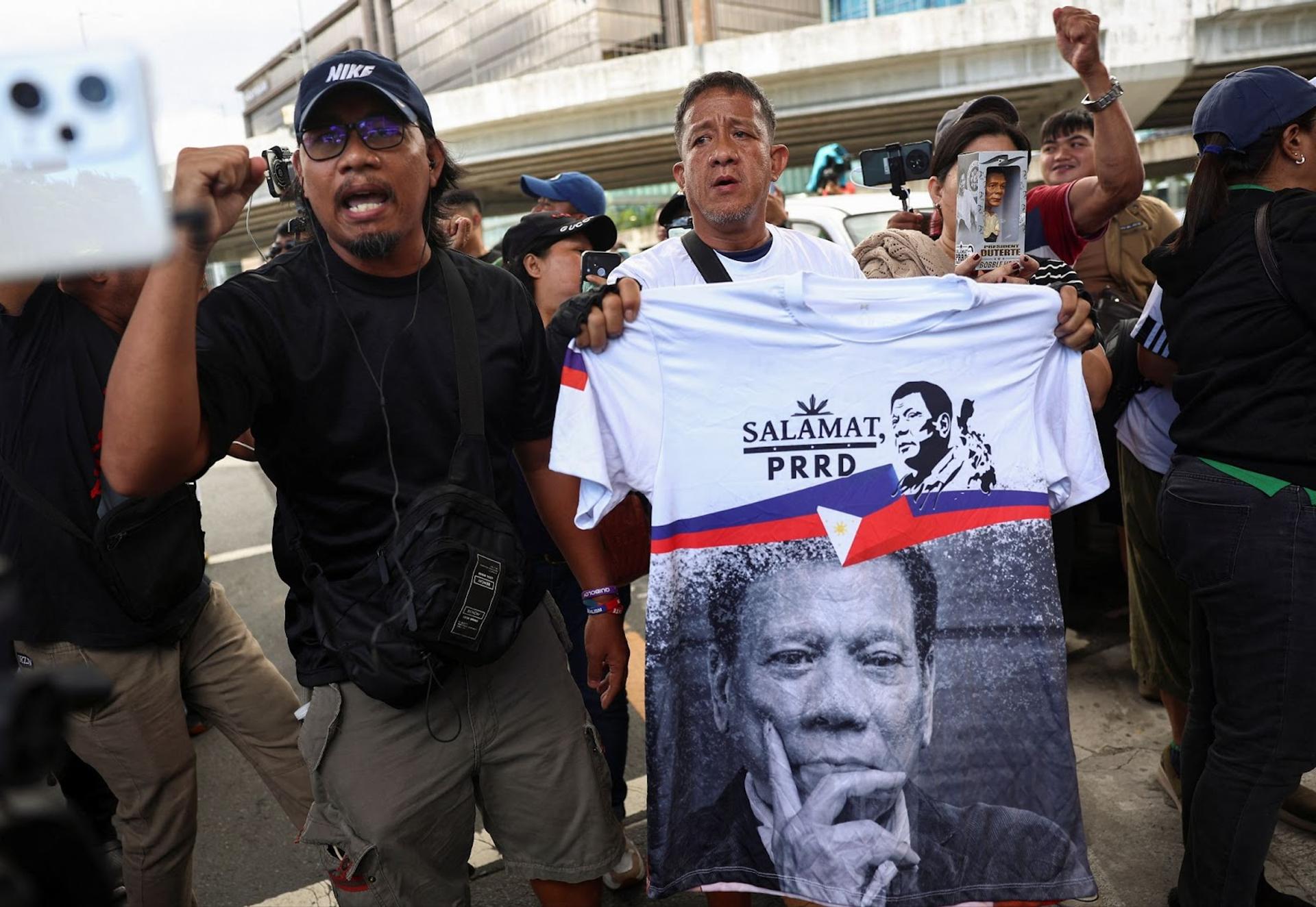 Supporters of Duterte outside the base where he’s being held