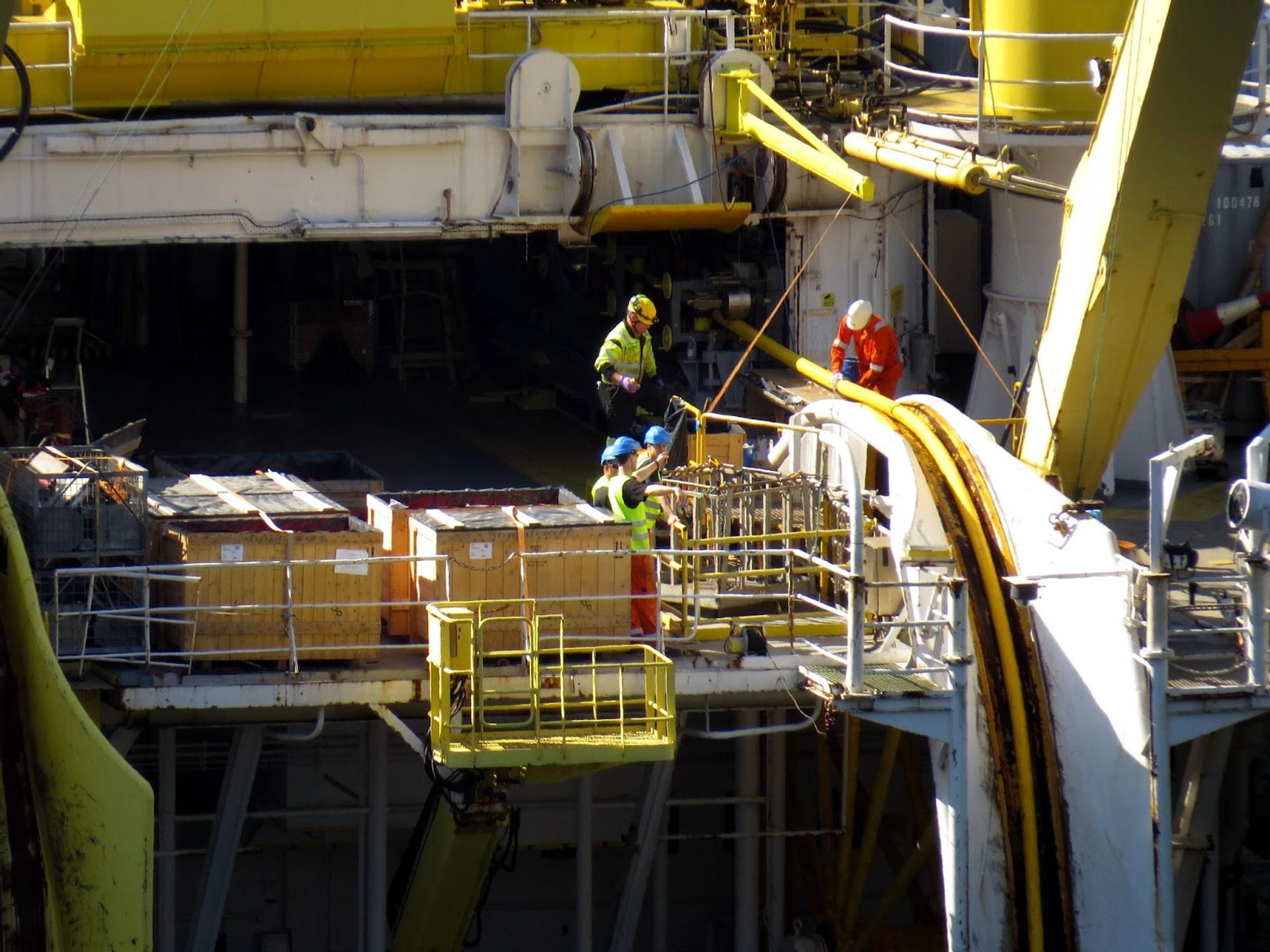 Workers laying a subsea cable.