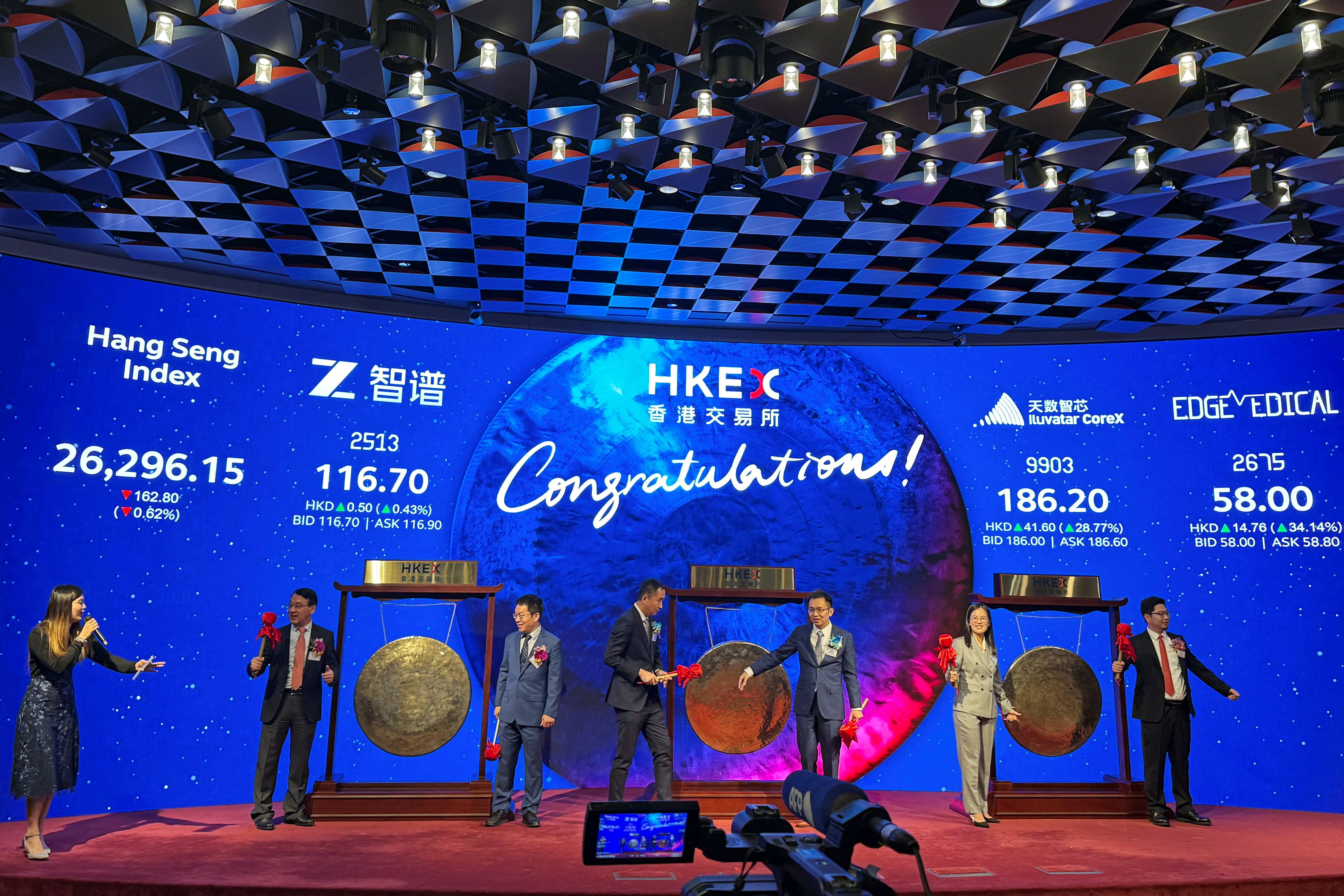 Executives from Zhipu AI, Shanghai Iluvatar CoreX and Shenzhen Edge Medical attend a listing ceremony in Hong Kong