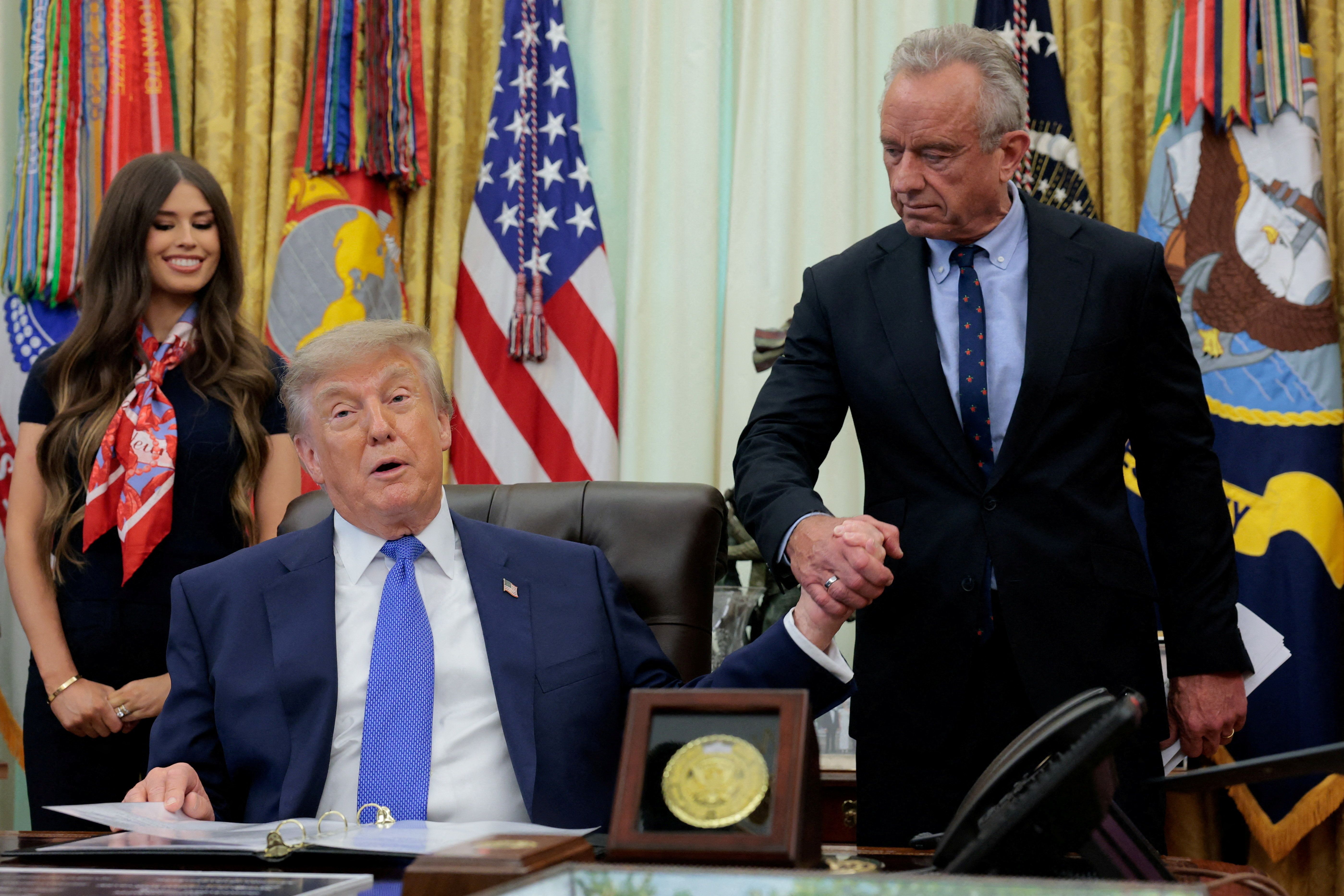 President Donald Trump holds hands with Secretary of Health and Human Services (HHS) Robert F. Kennedy Jr.