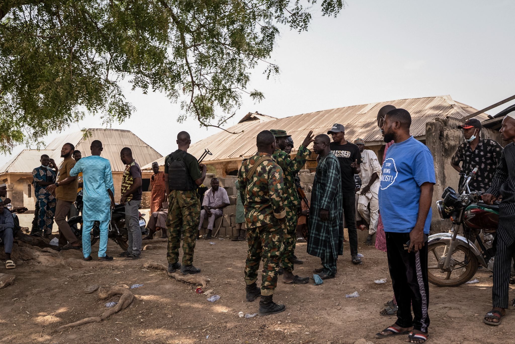 Nigerian Armed Forces interact with residents after an attack in Woro, Kwara state.