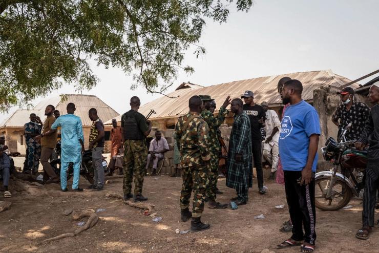 Nigerian Armed Forces interact with residents after an attack in Woro, Kwara state.