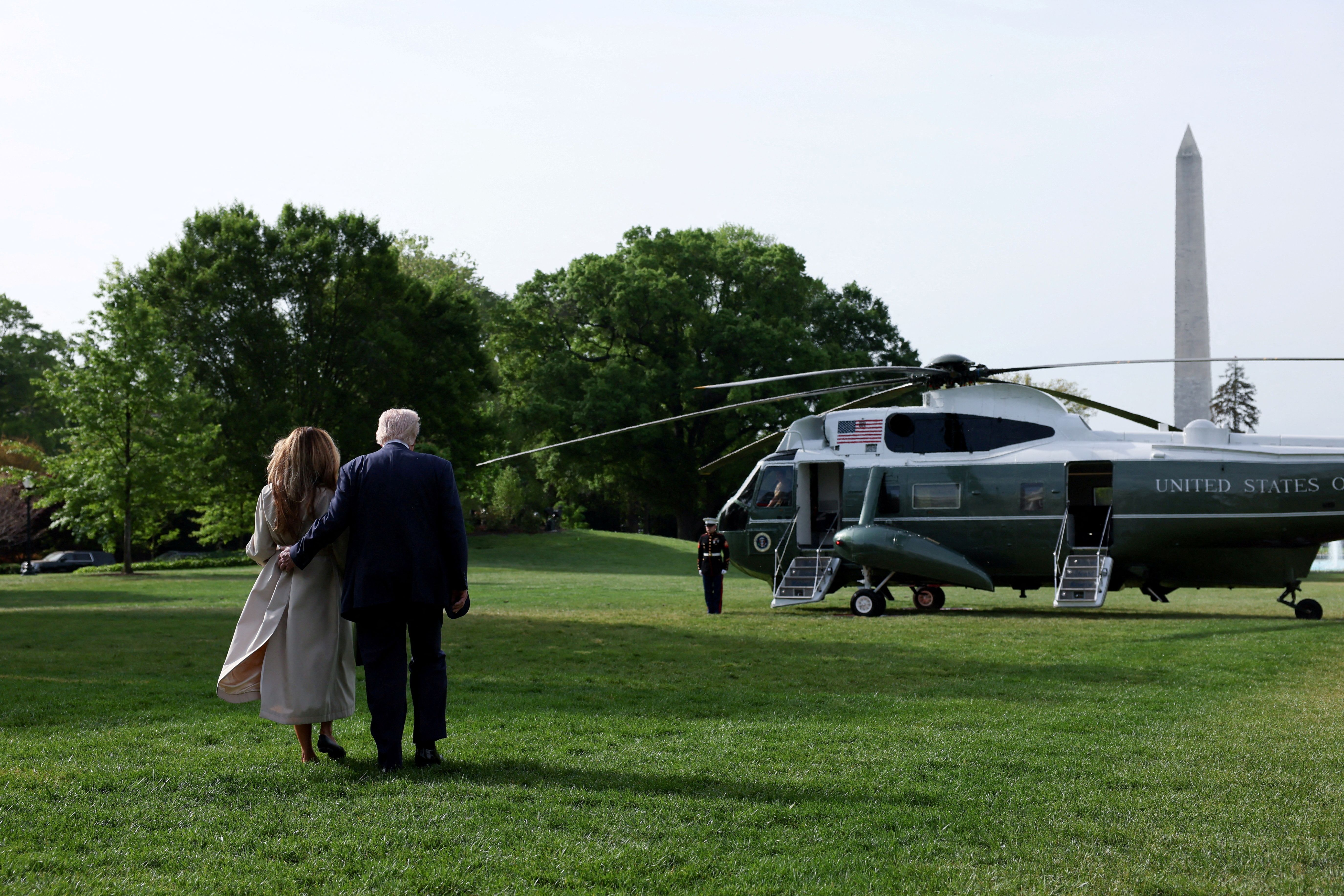 U.S. President Donald Trump and first lady Melania Trump walk to Marine One as they depart for Rome, Italy.