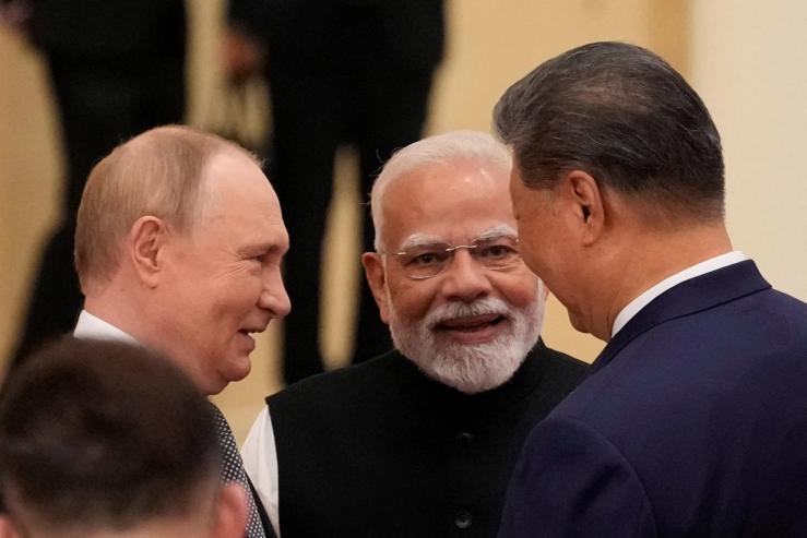 Indian Prime Minister Narendra Modi talks with Russian President Vladimir Putin and Chinese President Xi Jinping.