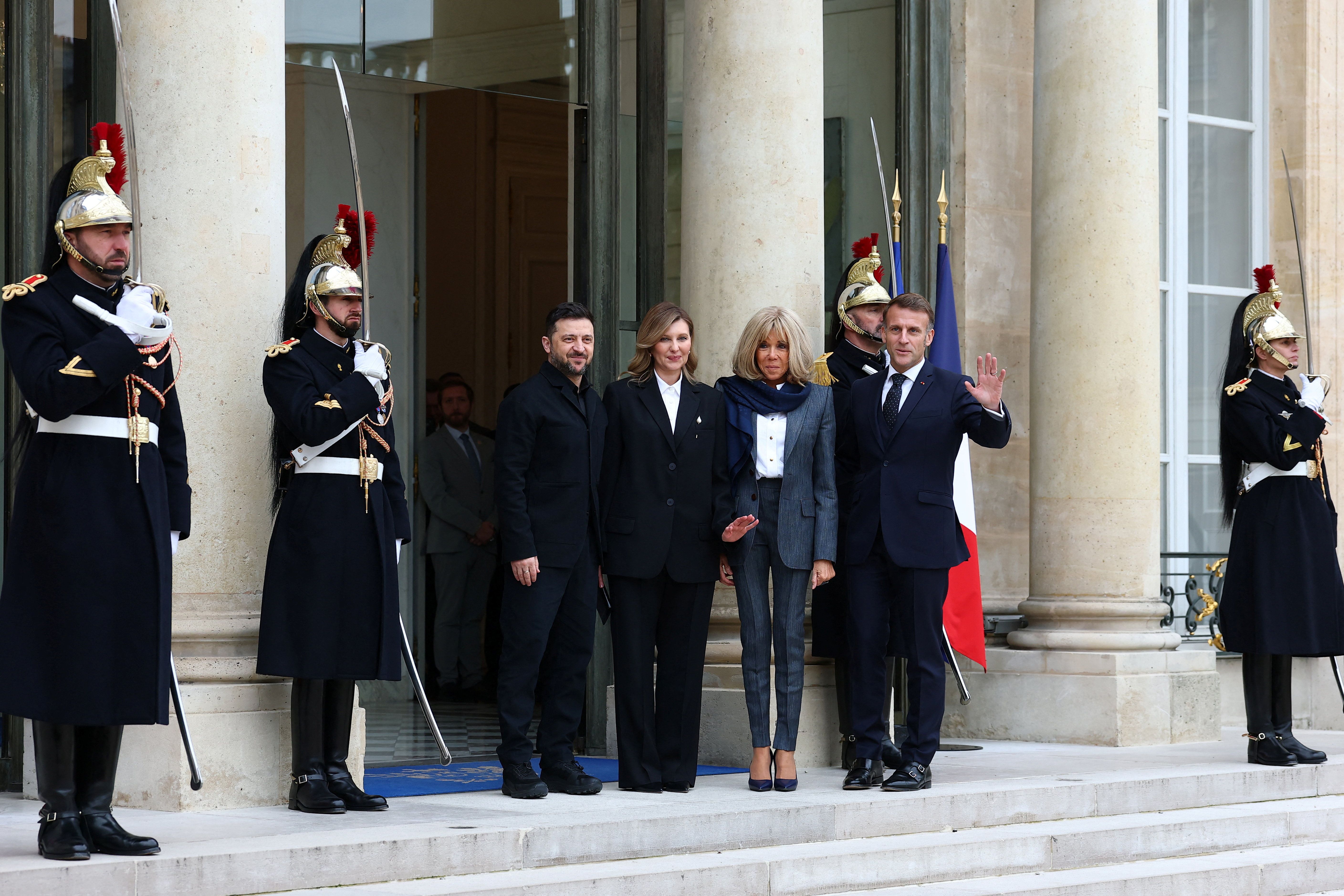French President Emmanuel Macron and his wife Brigitte Macron, Ukrainian President Volodymyr Zelenskiy and his wife Olena Zelenska pose for journalists at the Elysee Palace in Paris, France