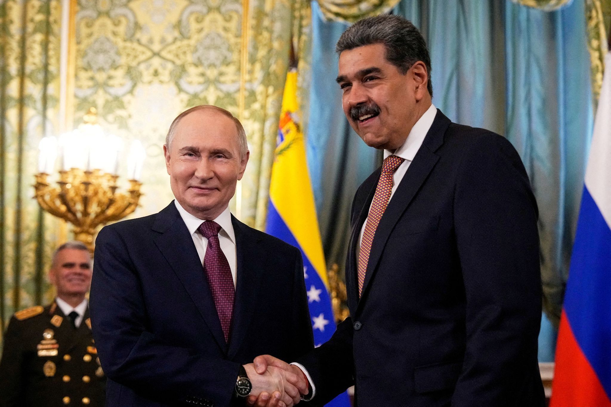 Russian President Vladimir Putin shakes hands with his Venezuelan counterpart Nicolas Maduro during a meeting at the Kremlin in Moscow