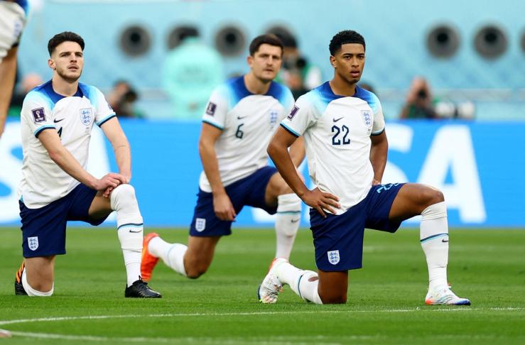 England’s players take the knee before their match against Iran