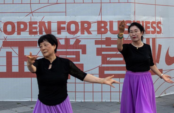 A sign reading open for business in Beijing.
