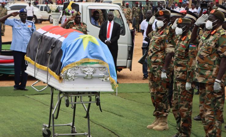 Members of the South Sudanese security forces salute the coffin of General David Majur Dak, the commander of the South Sudan People’s Defense Force.