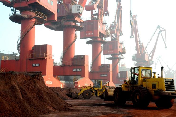 Workers transport soil containing rare earth elements for export at a port in Lianyungang, Jiangsu