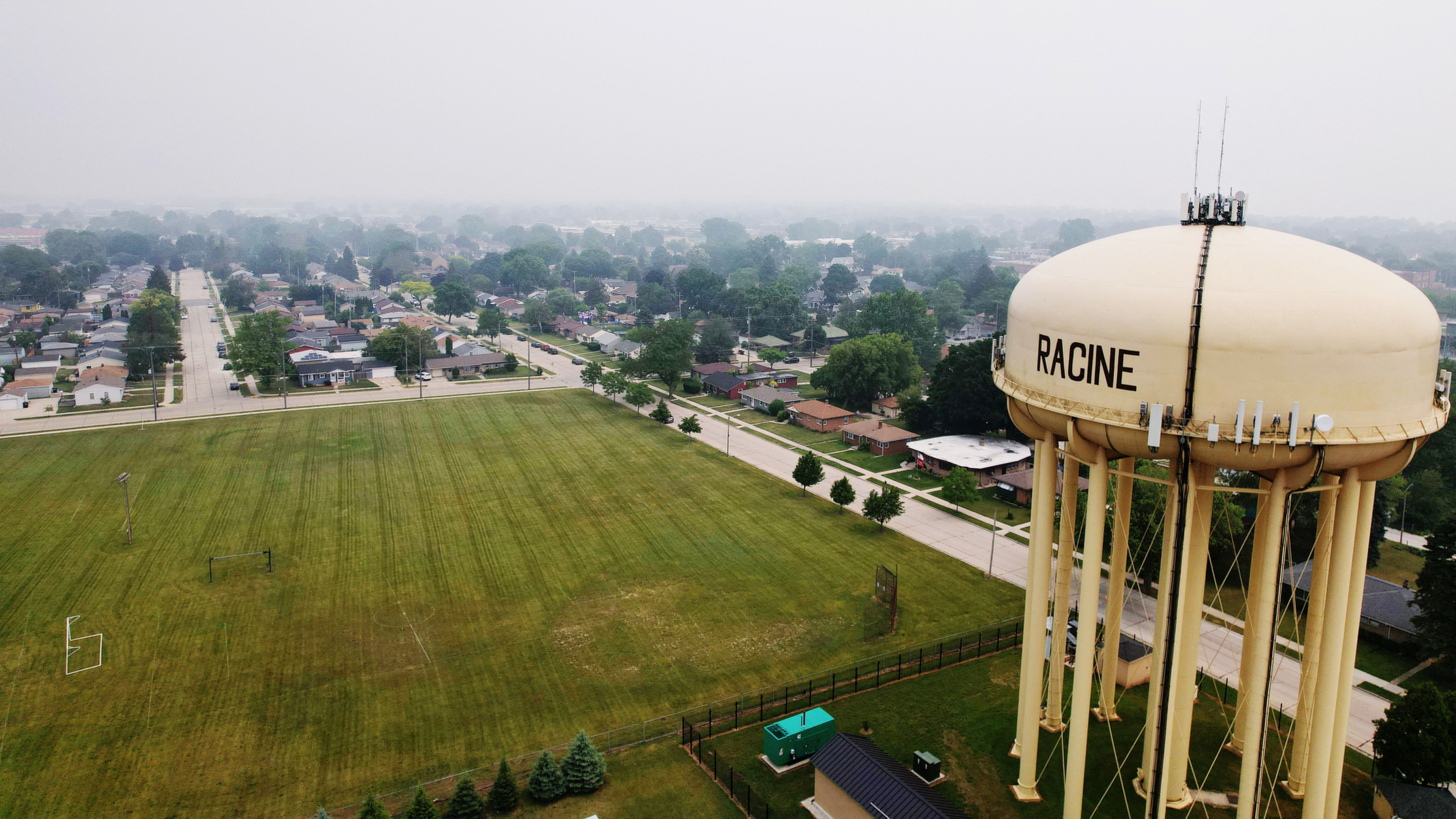 A water tower stands over the small industrial town of Racine, Wisconsin