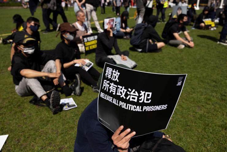 A demonstrator holds a banner outside the parliament marking the 35th anniversary of the Tiananmen Square crackdown in London, Britain
