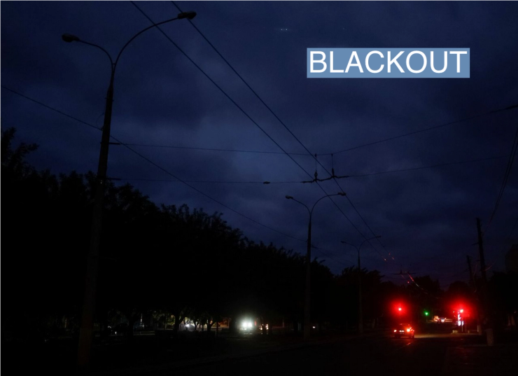 Cars move along a dark street during electricity shortage, amid Russia’s attack on Ukraine, in Mykolaiv, Ukraine