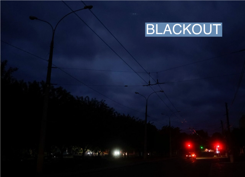 Cars move along a dark street during electricity shortage, amid Russia’s attack on Ukraine, in Mykolaiv, Ukraine