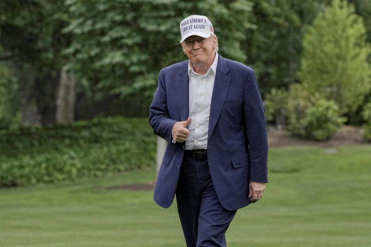 US President Donald Trump gives a thumbs up as he walks on the South Lawn of the White House.