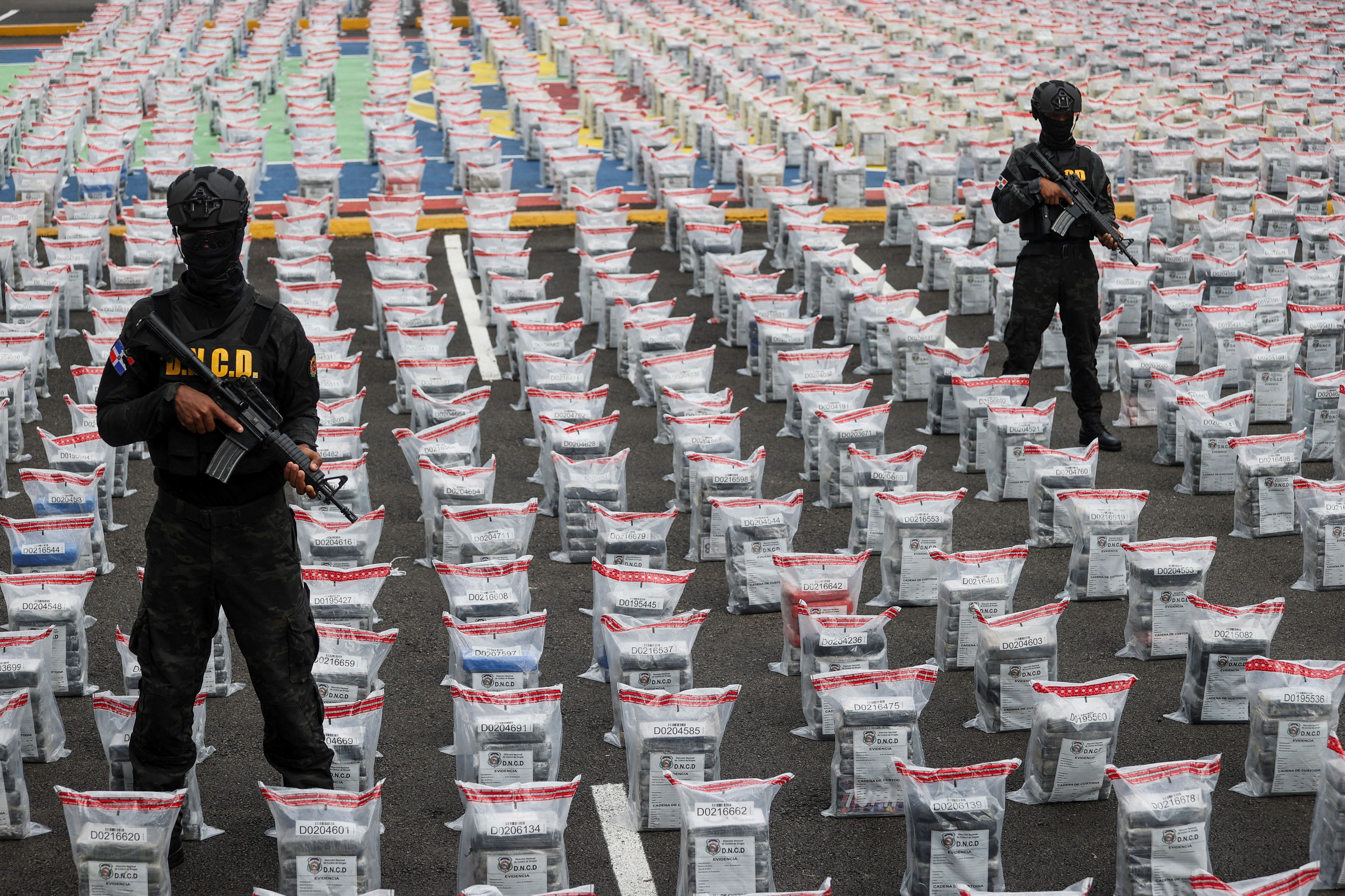 Agents of the National Drug Control Directorate (DNCD) stands guard amidst cocaine packages found in a banana shipment, in Santo Domingo, Dominican Republic.