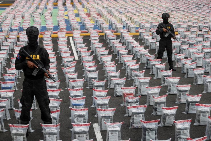 Agents of the National Drug Control Directorate (DNCD) stands guard amidst cocaine packages found in a banana shipment, in Santo Domingo, Dominican Republic.
