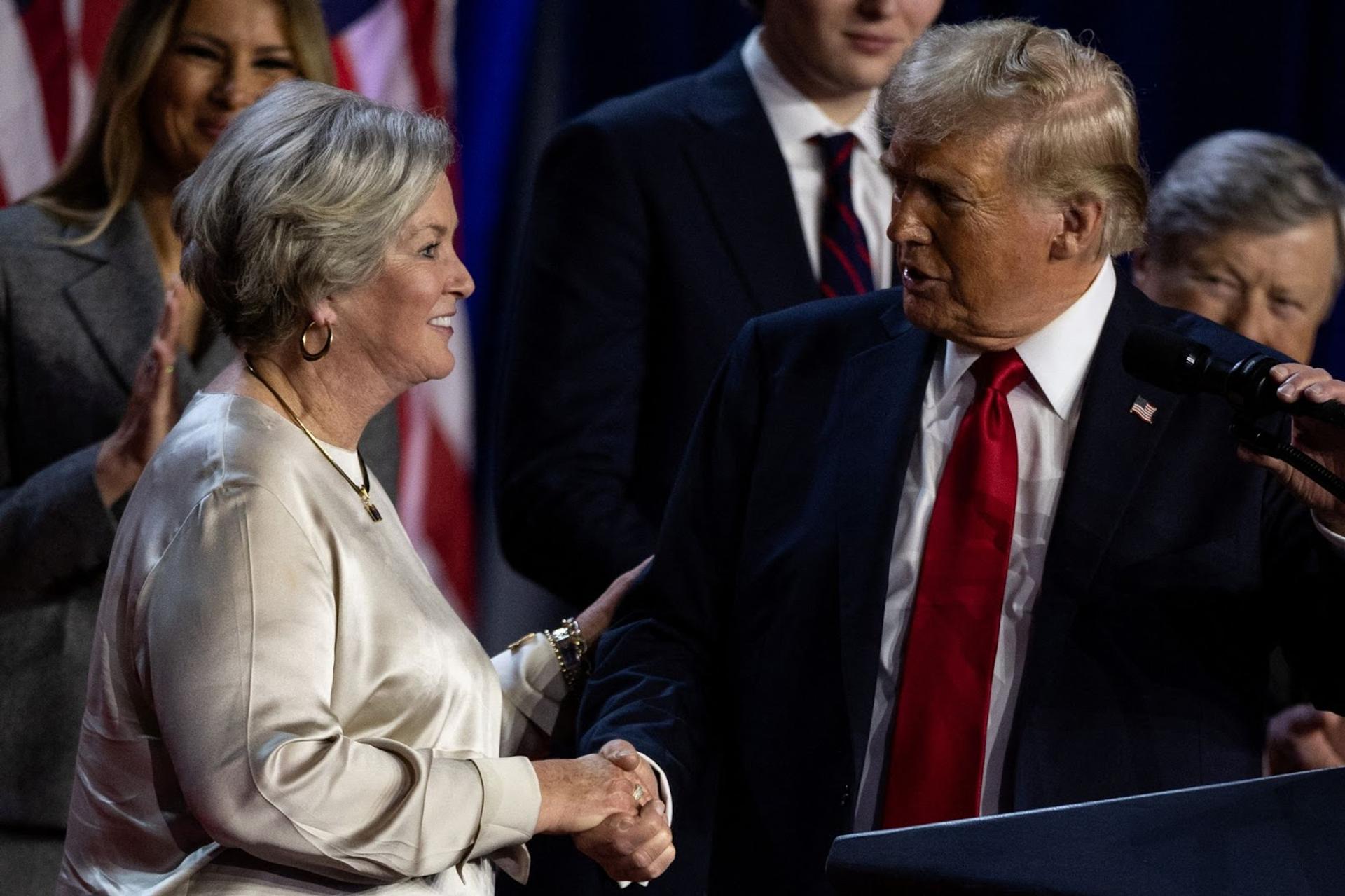 Donald Trump shakes hands with a smiling Susie Wiles at Palm Beach County Convention Center in Florida, US