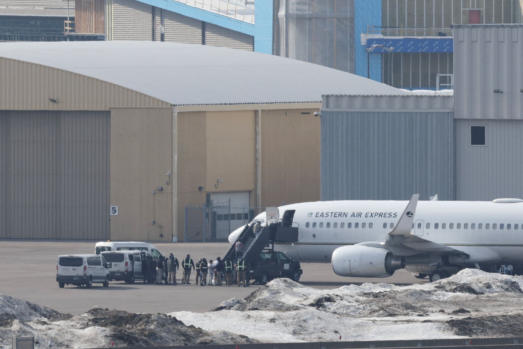 Detainees board a deportation flight on Eastern Air Express in Minneapolis.