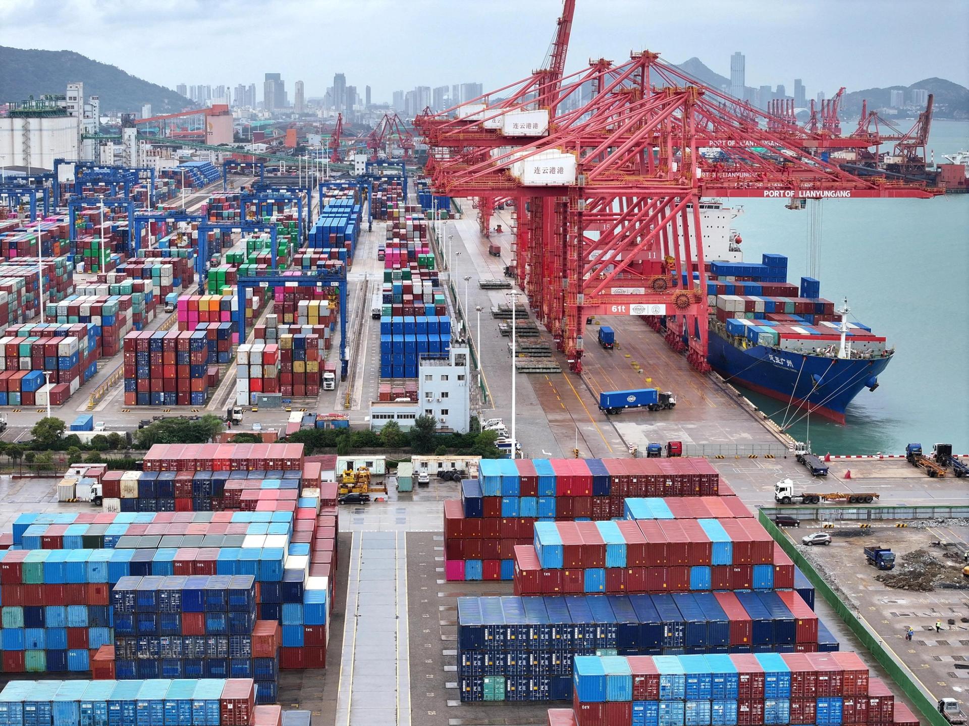 A drone view shows a cargo ship and shipping containers at the port of Lianyungang in Jiangsu province, China.