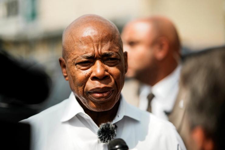 New York City Mayor Eric Adams, speaks with journalist as he attends a ribbon-cutting ceremony at his Queens campaign office in Queens.