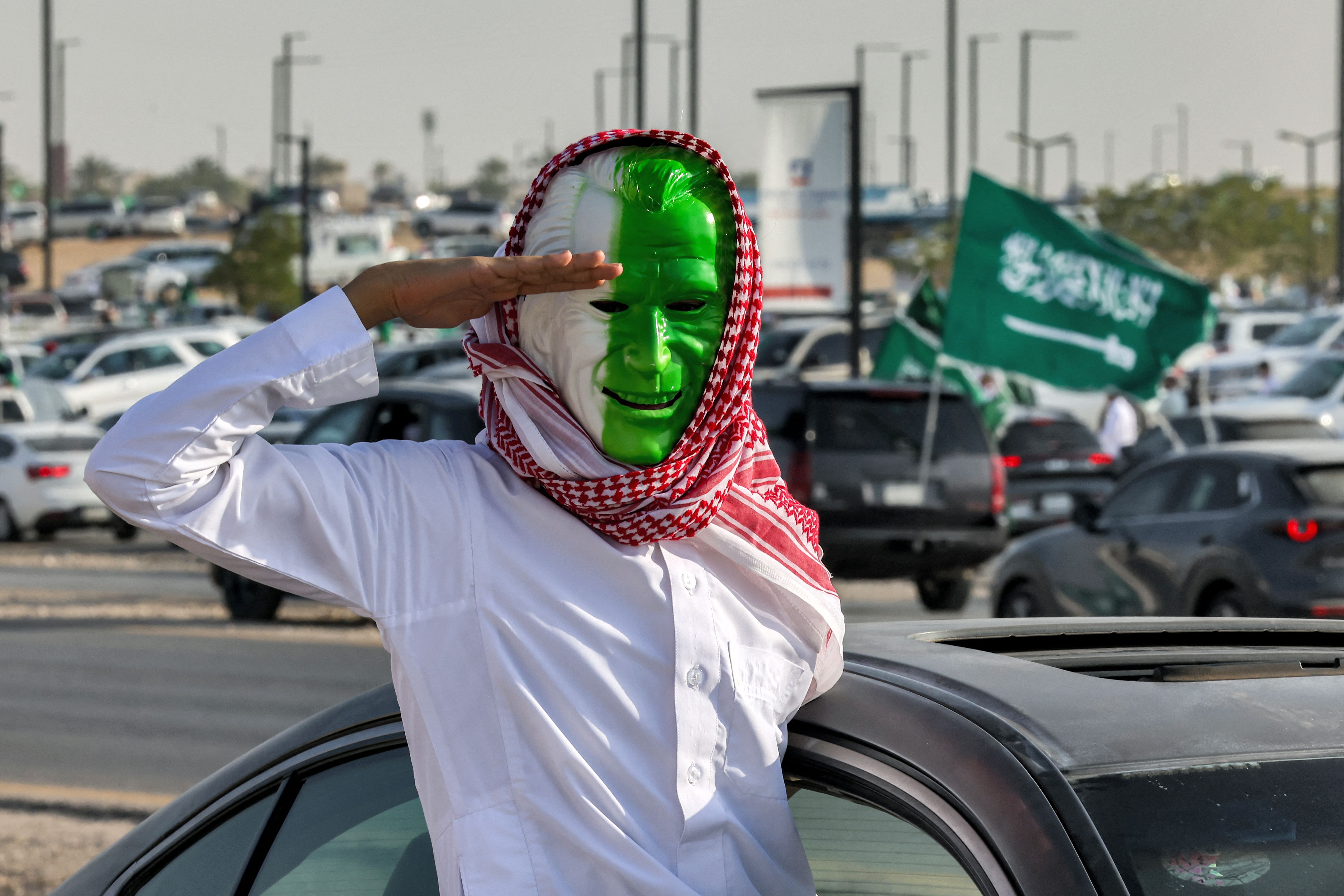  A man wearing a green and white Purge-like face mask during national day celebrations in 2023.