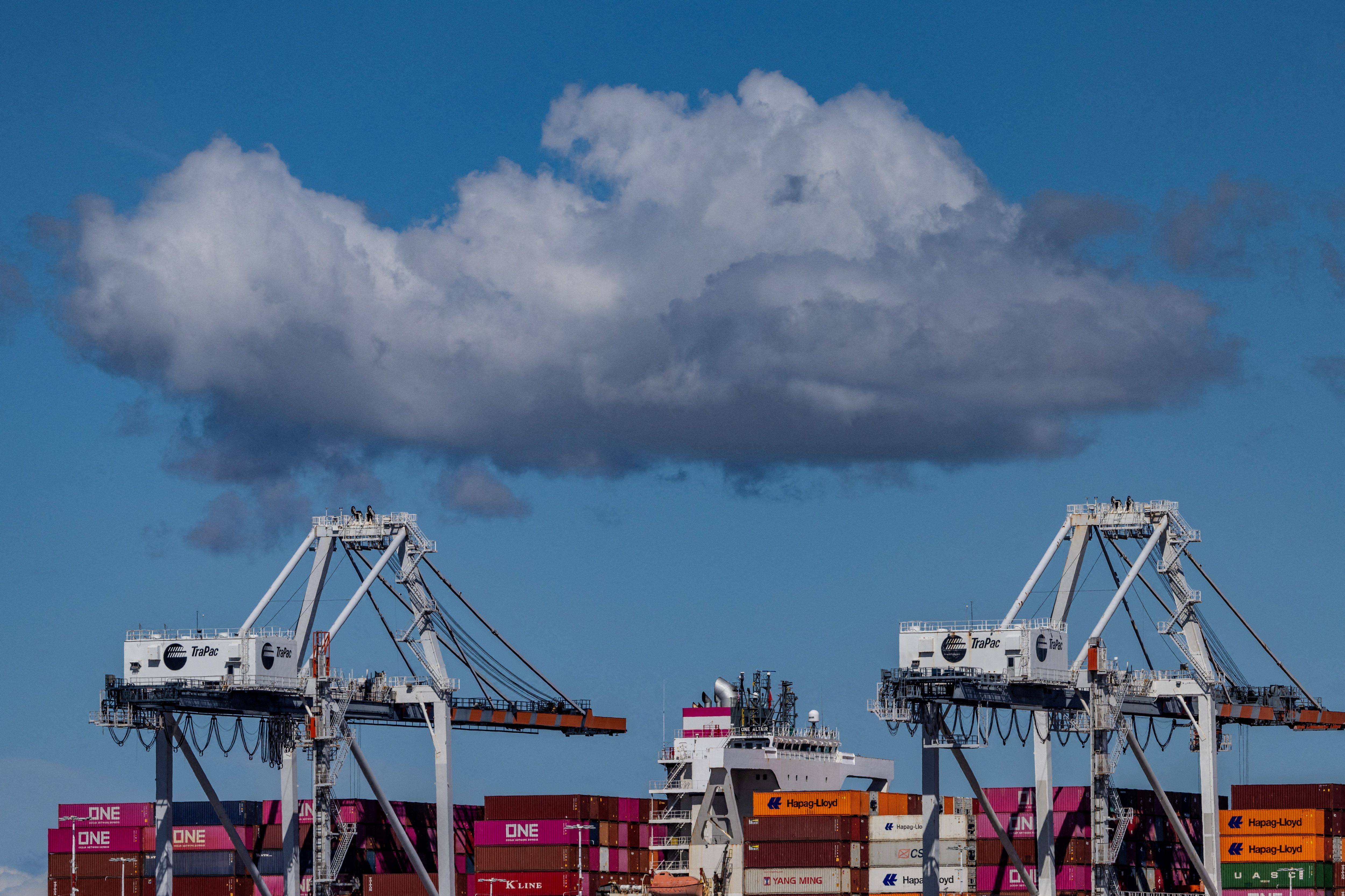 A cargo ship full of shipping containers is seen at the port of Oakland.