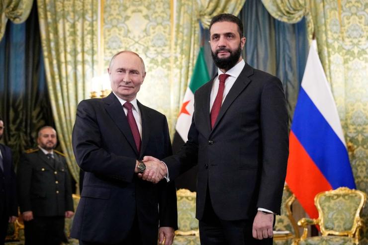Russia’s President Vladimir Putin shakes hand with Syrian President Ahmed Al-Sharaa.